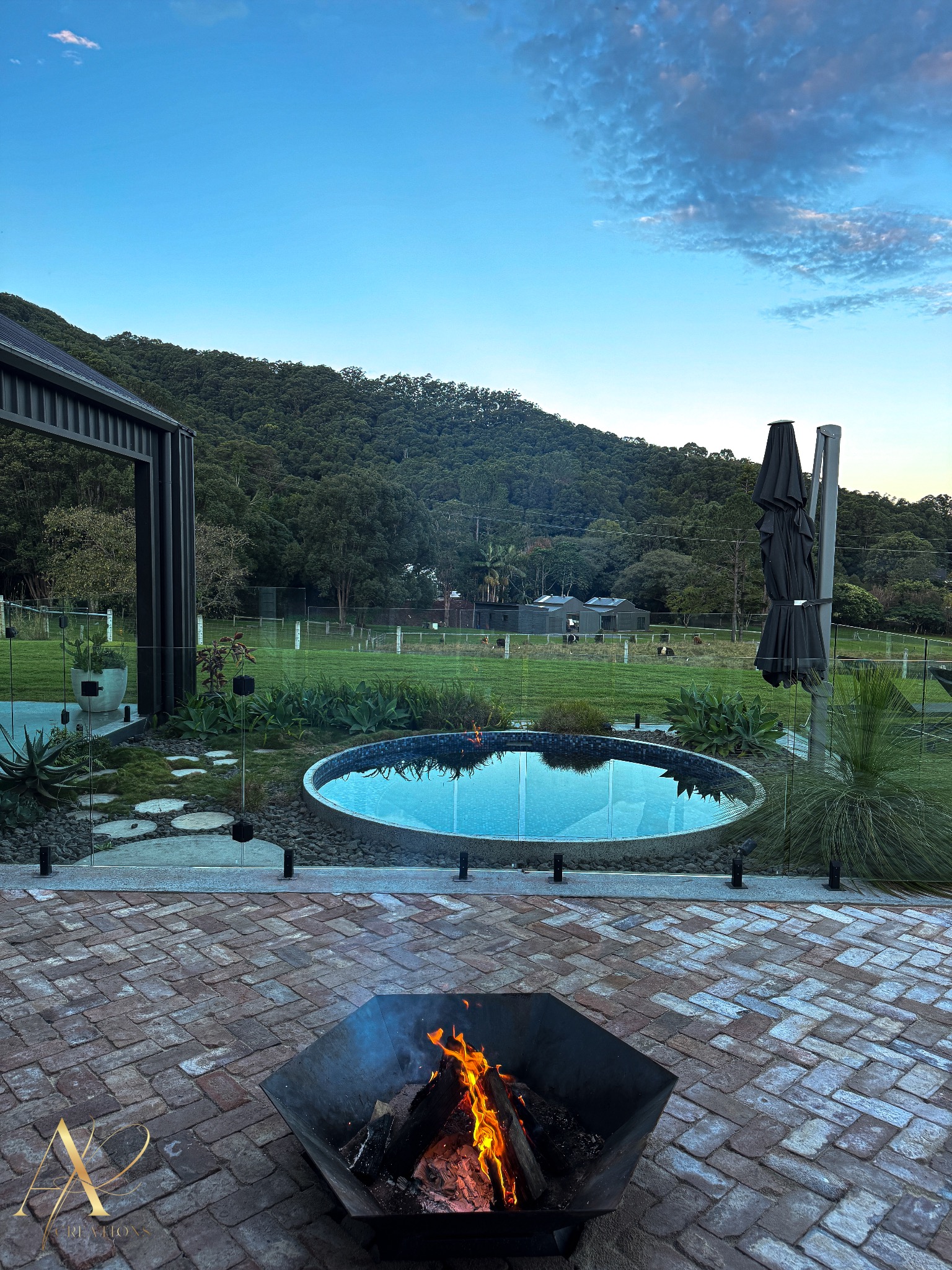 Valley-view pool retreat — circular plunge pool, fire pit and hinterland backdrop.