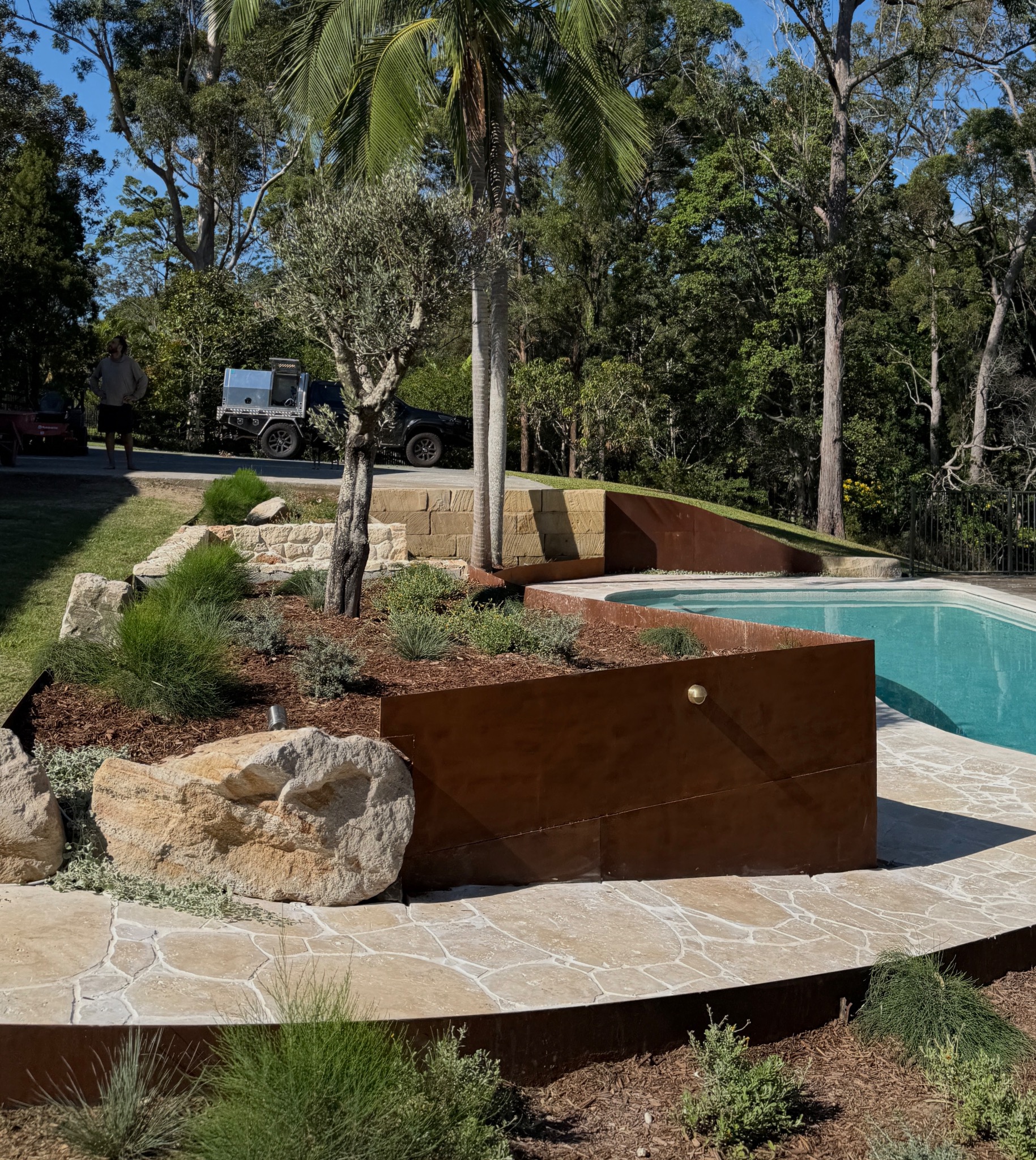Curved corten beds, sandstone retaining, olive tree feature and pool surrounds.